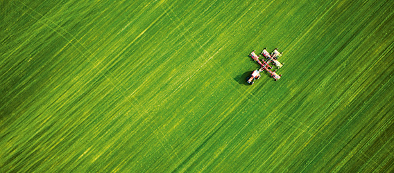 Aerial view of a tractor mowing a large field of grass in North Carolina (photo)