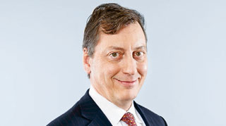 John R. Dacey – Group Chief Strategy Officer (photo)