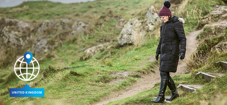 Woman walking down natural steps in a UK landscape (photo)