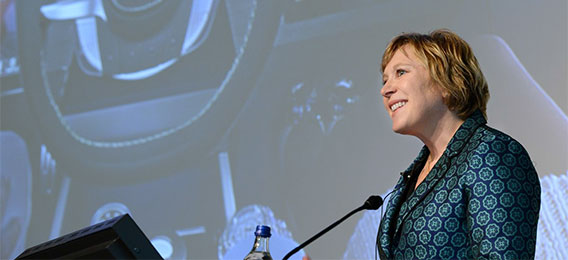 Jayne Plunkett holding a presentation on a stage (photo)