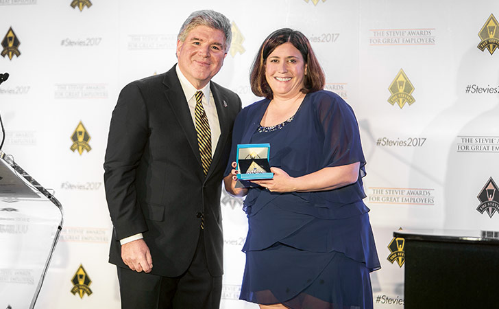 Jennifer Reid of Finance Reinsurance Americas collects the Stevie Silver Award we received for an interactive new finance training programme (photo)